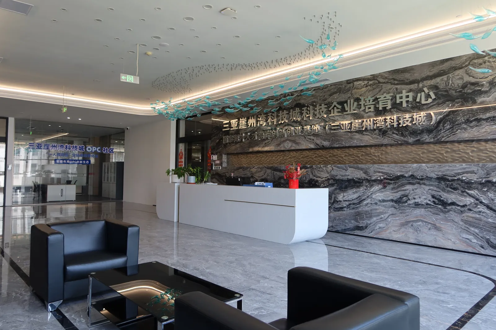 Reception desk with backlit signage wall
