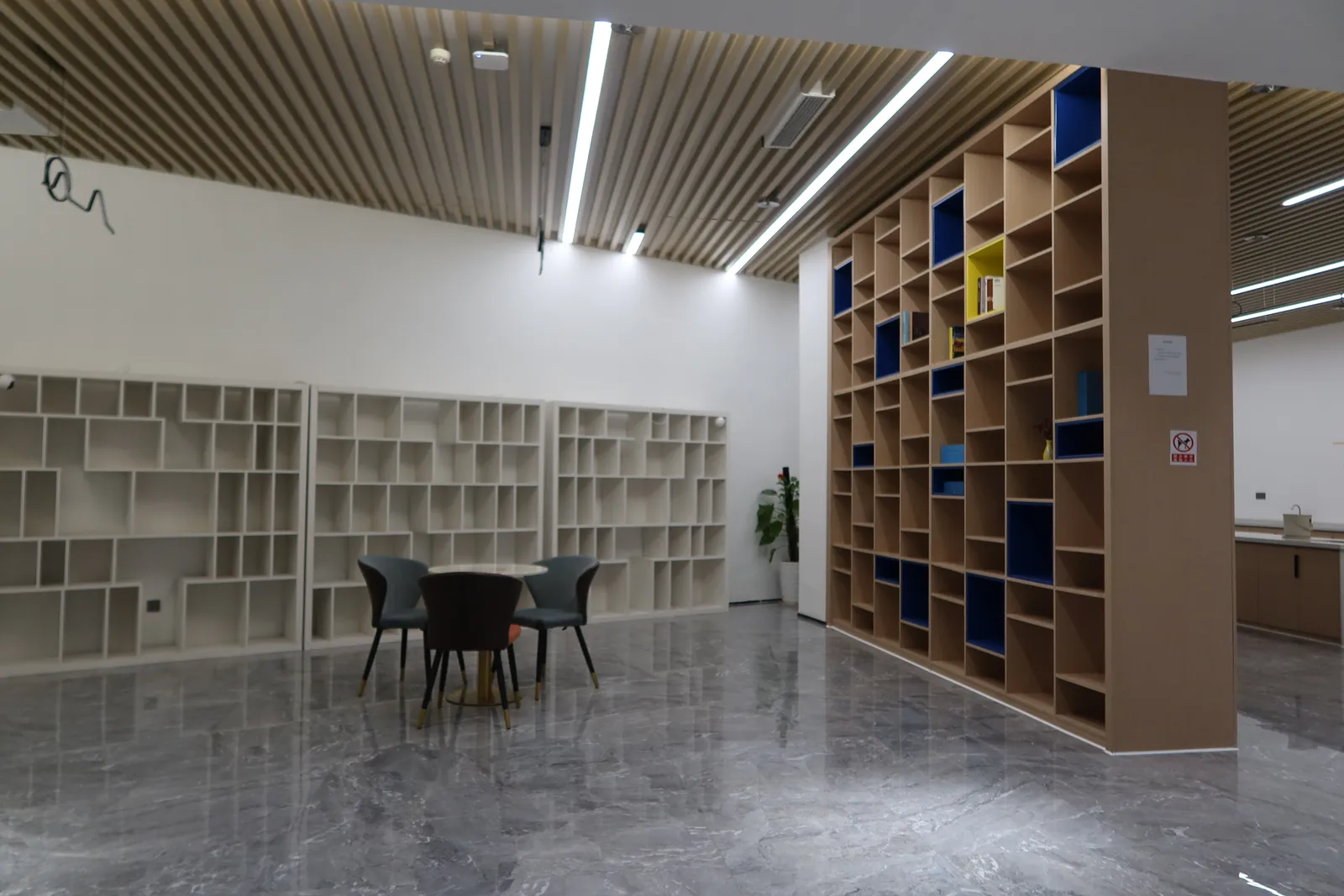 Lounge seating next to open bookshelves