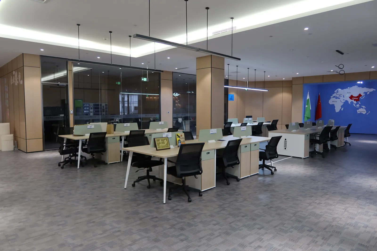 Open desks with a world map wall behind them