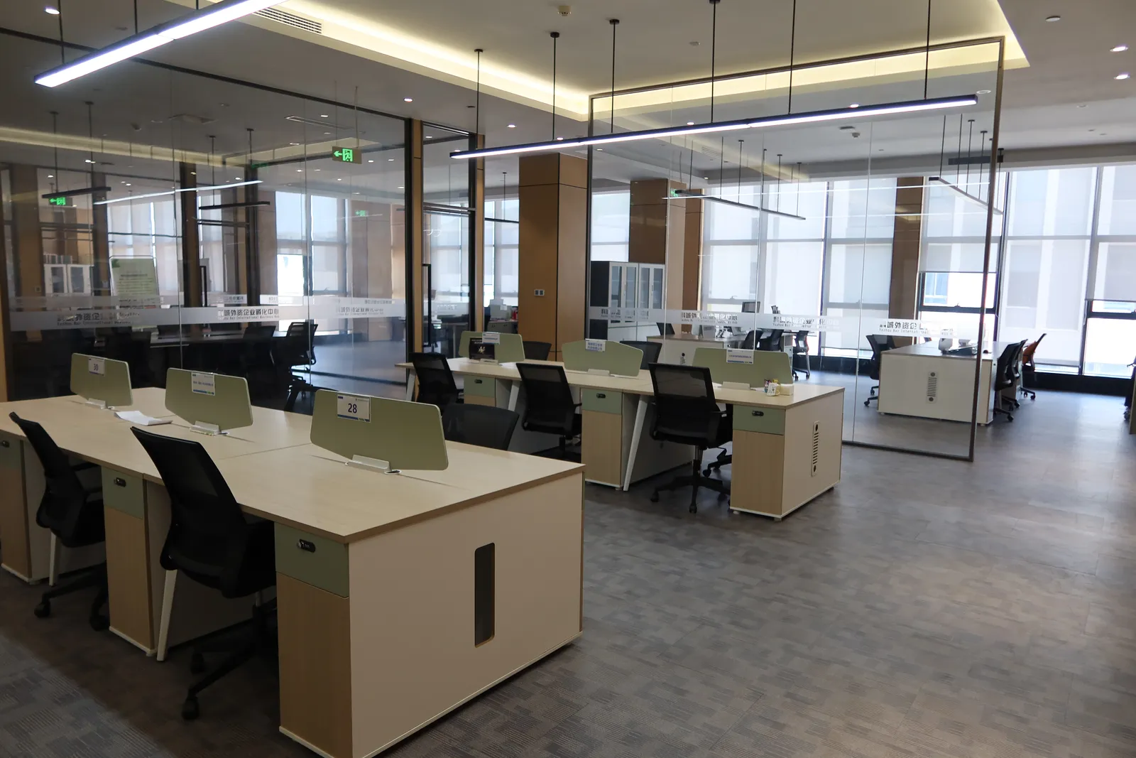 Rows of shared desks with numbered workstations